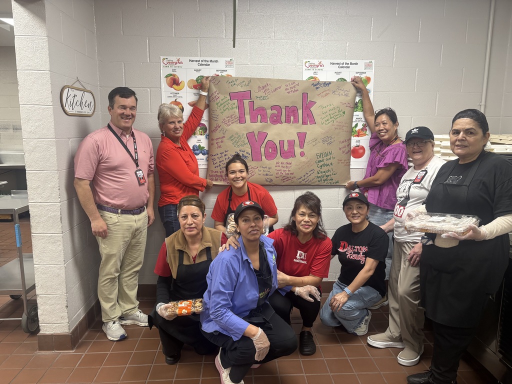 Cafeteria workers and principal holding a sign that says Thank You! for cafeteria appreciation day.