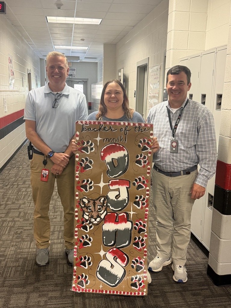 AP, teacher, and principal holding Teacher of the Month sign