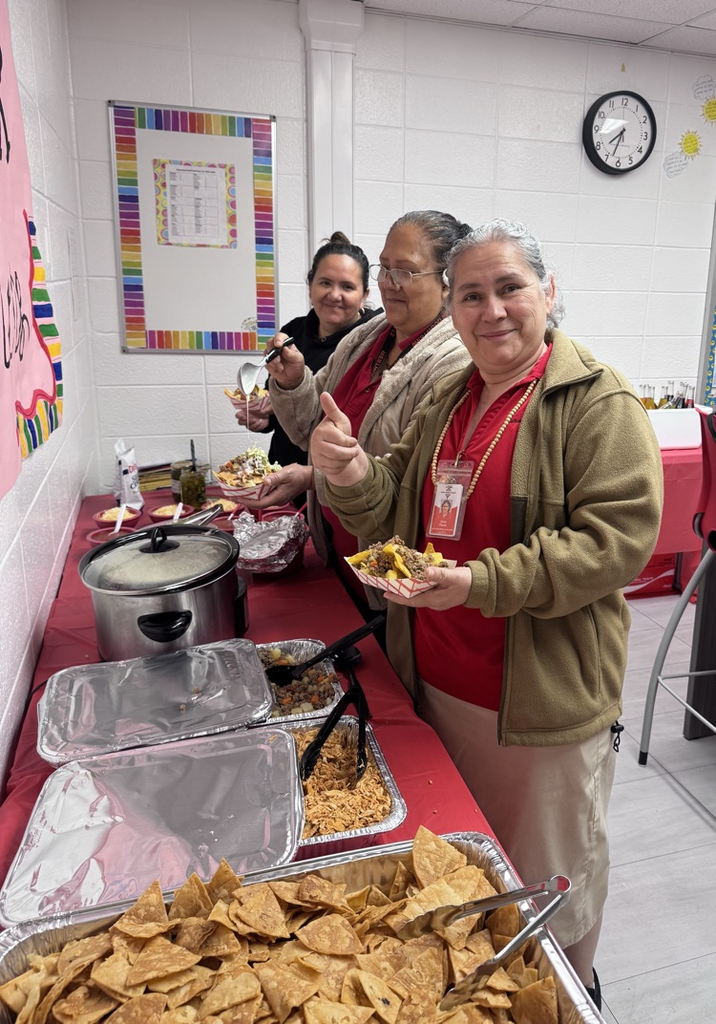 Our three custodians fixing their lunch from the nacho bar provided by PTO