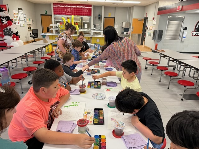 Both classes working on painting their flowers while teachers and Mrs. Meza supervised their paintings