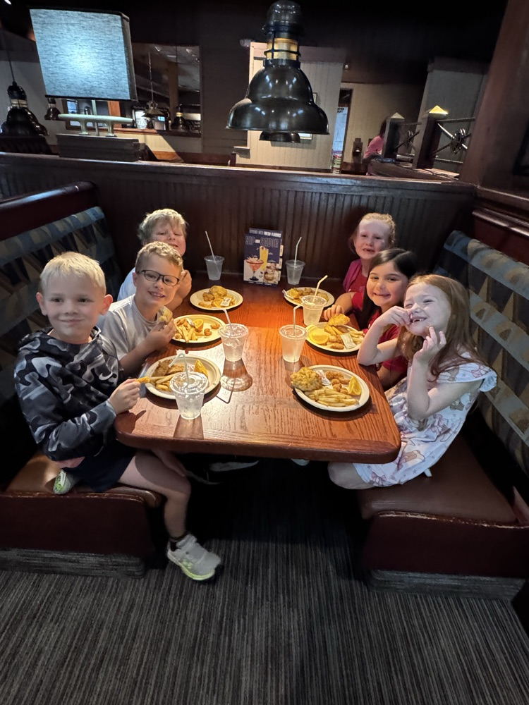 A group of students sitting on a table enjoying their lunch 