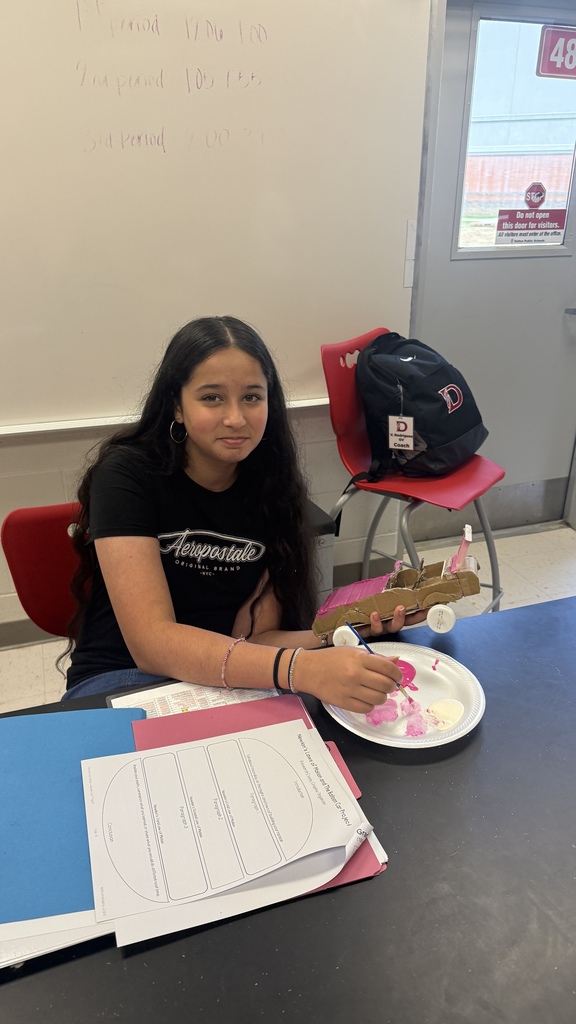 student painting balloon car