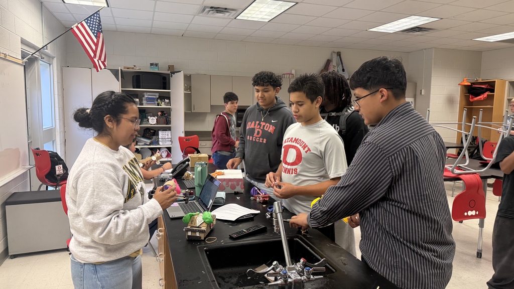 students and teacher discussing balloon car