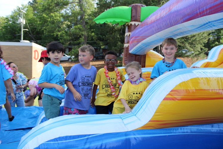 A group of students playing on the inflatables 