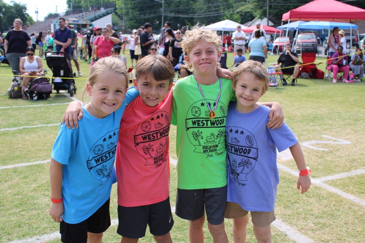 Second grade 50 yard dash participants standing on the field  
