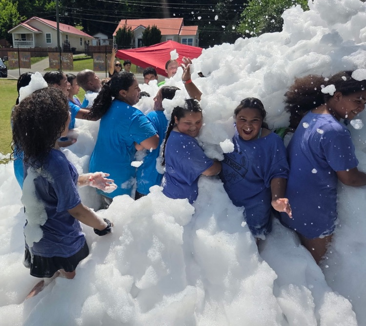 Fifth graders playing in the foam at their fun day/field day party 