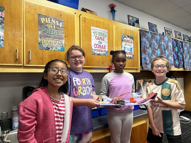 Students holding the simple machine that they created 
