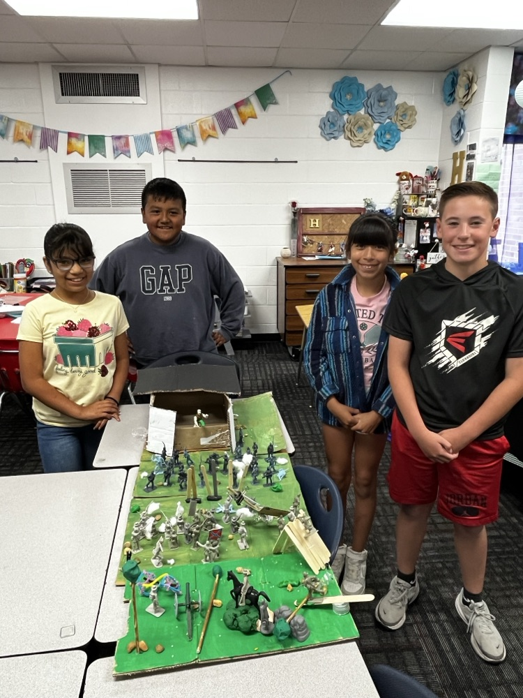 Students holding the simple machine that they created as a team