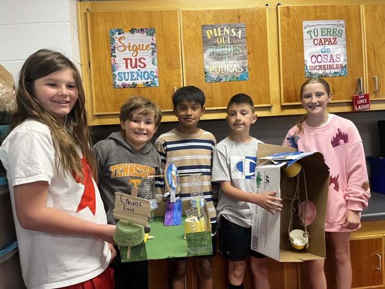 Students holding the simple machine that they created as a team