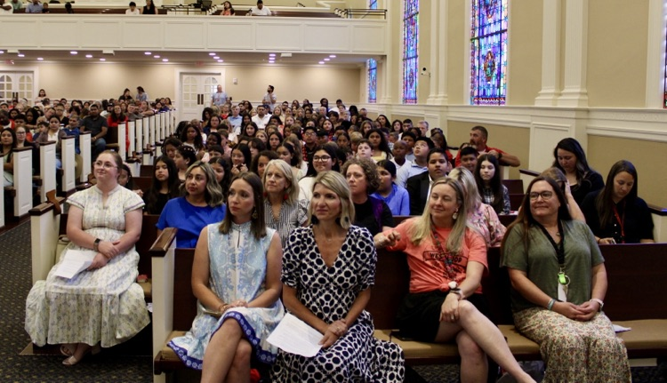 5th grade graduates and Westwood teachers sitting at the graduation ceremony 