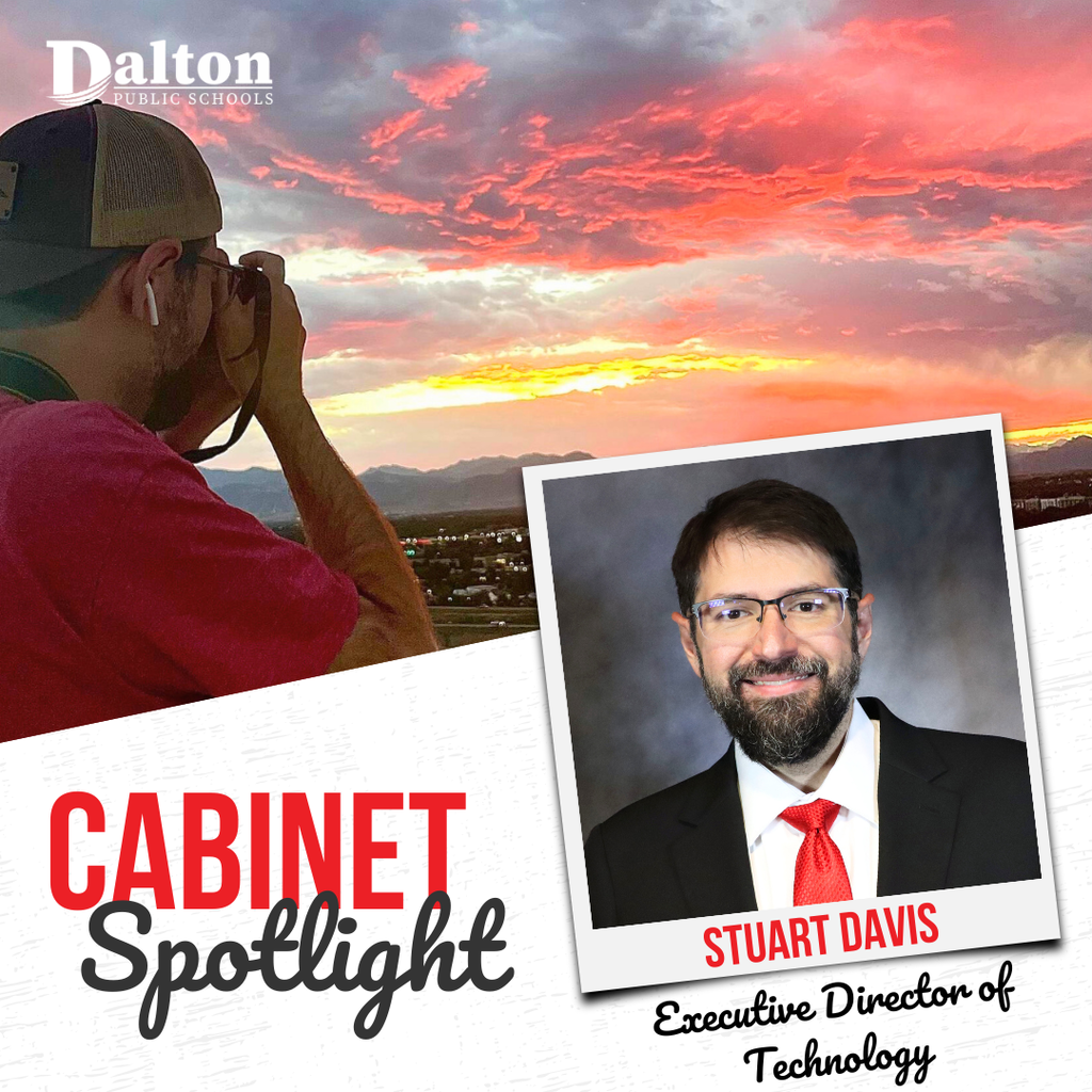 A Dalton Public Schools āCabinet Spotlightā graphic highlights Stuart Davis, Executive Director of Technology. The design features a large scenic photo of a person photographing a vibrant pink and orange sunset over mountains, alongside a framed professional portrait of Stuart Davis wearing glasses, a dark suit, and a red tie. The Dalton Public Schools logo appears in the top left corner, with āCabinet Spotlightā displayed prominently in bold red and black text.