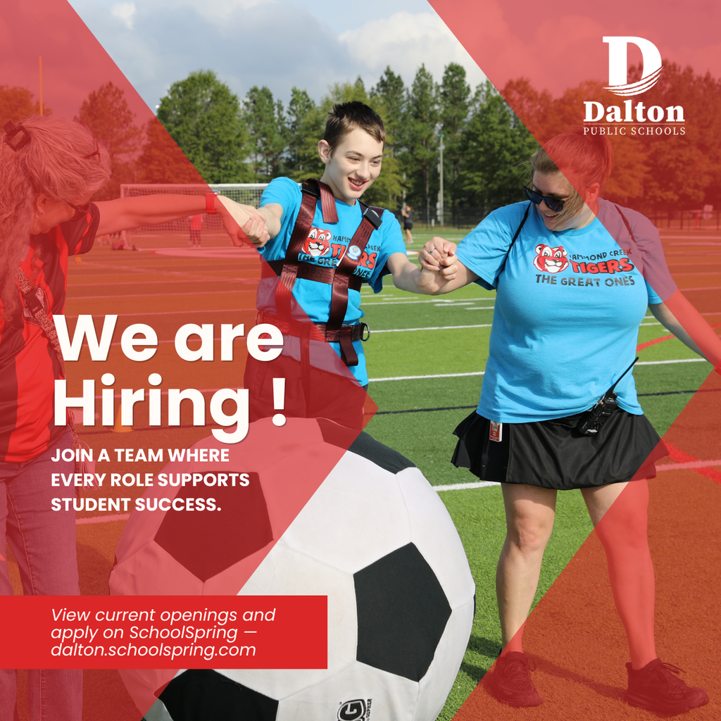 A Dalton Public Schools recruitment graphic shows staff members assisting a student during an adaptive physical education activity on a school athletic field. The student and staff are smiling and holding hands while standing beside an oversized soccer ball. Large white text reads, āWe are Hiring!ā followed by, āJoin a team where every role supports student success.ā The Dalton Public Schools logo appears in the top right corner, and a red banner at the bottom directs viewers to apply at ādalton.schoolspring.com.ā