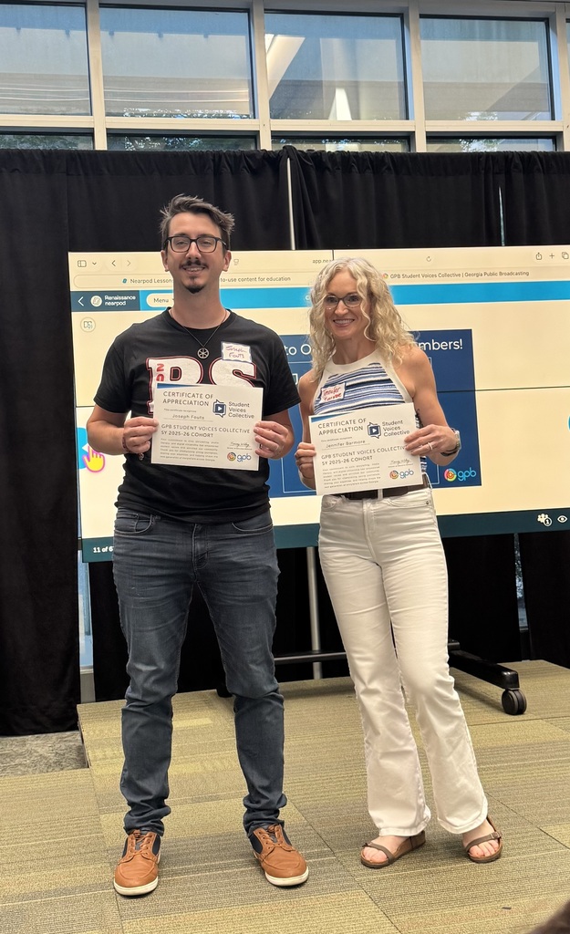 Mrs. Jennifer Barmore and a Georgia Public Broadcasting staff member pose with certificates celebrating Hammond Creek Middle School student journalists whose multimedia stories were published through the GPB Student Voices Collective.