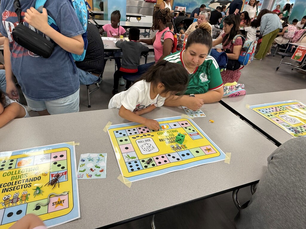 On Tuesday, June 16, the Rising Pre-K and Kindergarten Summer Transition Program hosted its first annual Magical Math Family Workshop, inviting students and families to explore the joy of numeracy through hands-on learning stations.  This year’s theme, “A Bug’s Life,” brought together the excitement of math and science as students worked through six engaging stations that combined counting, problem-solving, and insect-themed fun! From plastic spiders and web mats to fly swatters and dice games, every activity was designed to spark curiosity and build foundational math skills in a playful, memorable way.  Families rotated through stations including:  Roll, Find, and Stamp – practicing number recognition and fine motor skills Race to Fill – counting and comparing using dice, cups, and pom-poms How Many Bugs Am I Hiding? – building estimation and early addition skills Subitizing Cups – recognizing quantities quickly using dot stickers and patterns Smack the Bug Counting Game – developing number fluency with a fun twist Collecting Bugs – exploring preschool-level addition with bugs and butterflies It was a fantastic afternoon of math, movement, and memory-making for our young learners and their families