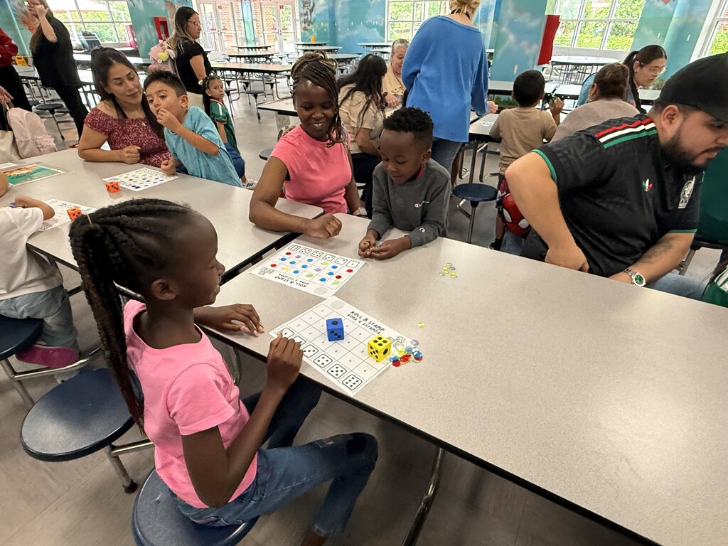 On Tuesday, June 16, the Rising Pre-K and Kindergarten Summer Transition Program hosted its first annual Magical Math Family Workshop, inviting students and families to explore the joy of numeracy through hands-on learning stations.  This year’s theme, “A Bug’s Life,” brought together the excitement of math and science as students worked through six engaging stations that combined counting, problem-solving, and insect-themed fun! From plastic spiders and web mats to fly swatters and dice games, every activity was designed to spark curiosity and build foundational math skills in a playful, memorable way.  Families rotated through stations including:  Roll, Find, and Stamp – practicing number recognition and fine motor skills Race to Fill – counting and comparing using dice, cups, and pom-poms How Many Bugs Am I Hiding? – building estimation and early addition skills Subitizing Cups – recognizing quantities quickly using dot stickers and patterns Smack the Bug Counting Game – developing number fluency with a fun twist Collecting Bugs – exploring preschool-level addition with bugs and butterflies It was a fantastic afternoon of math, movement, and memory-making for our young learners and their families