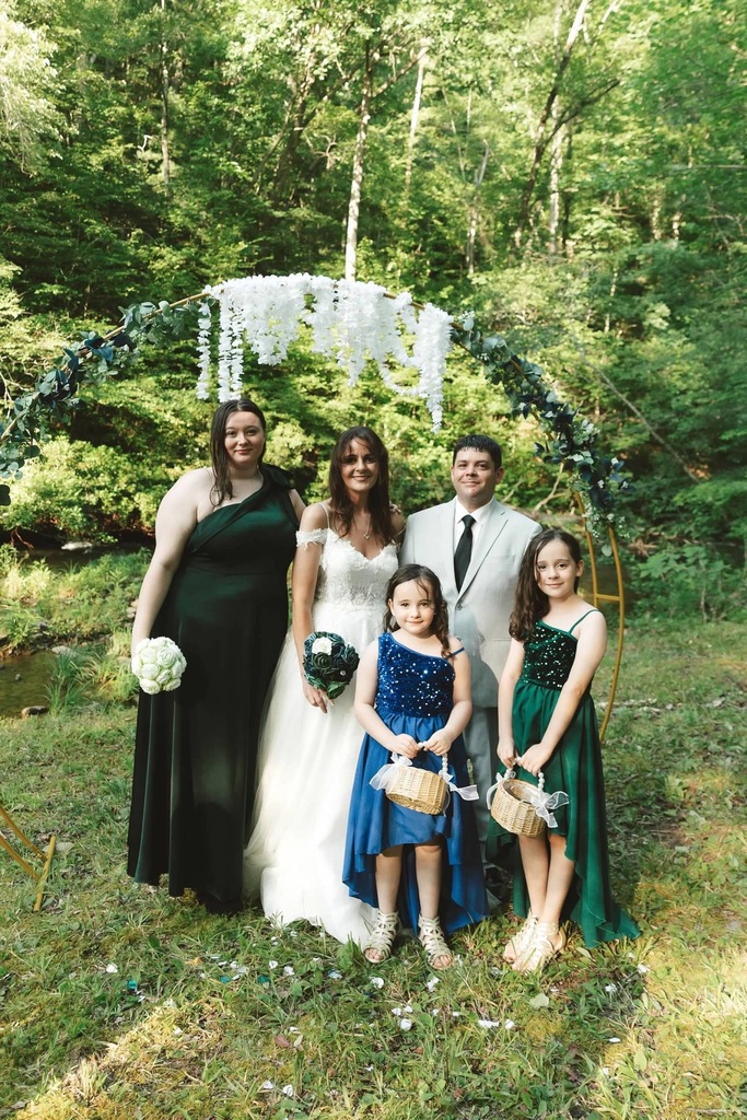 people stand in wedding attire