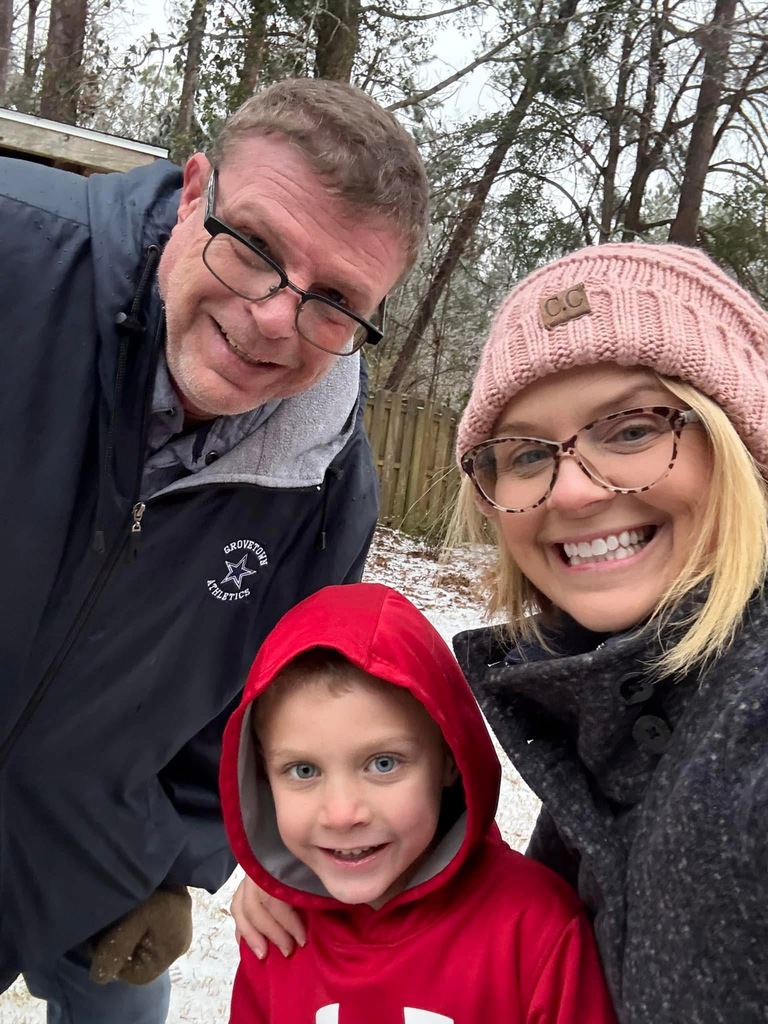 Man woman and child pose for a selfie