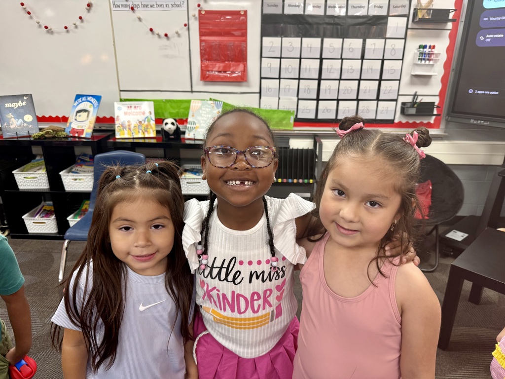 3 kindergarten students smiling for a picture