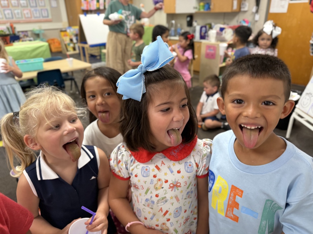 pre-k students showing their green colored tongues