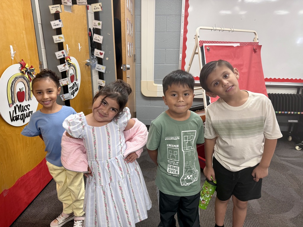 4 kindergarten students smiling for a picture