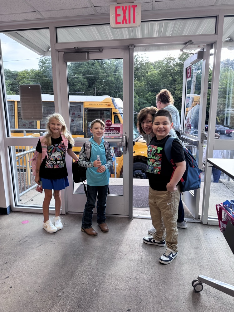 Students entering the school after getting off the bus 
