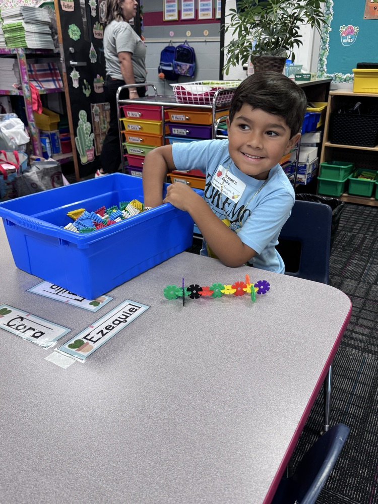 Student playing with manipulatives at his desk  