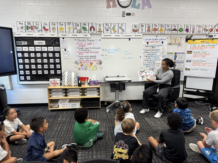 Miss Angie reading a book to the class