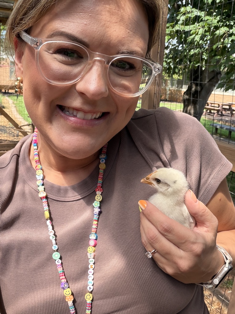 teacher holding our first baby chick