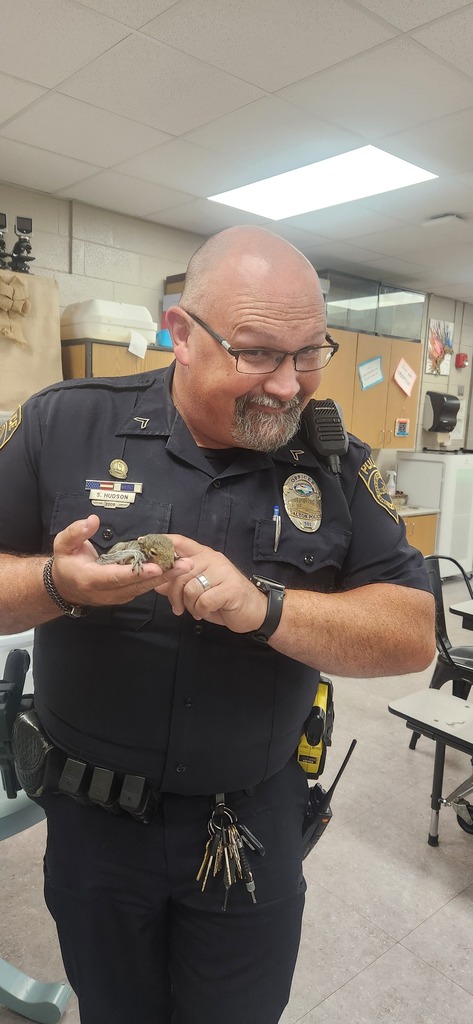 our school resource officer holding one of the bearded dragons