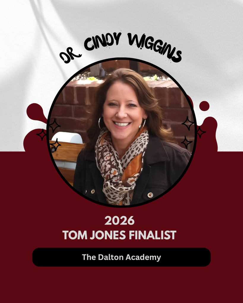 A dark red and white graphic featuring a circular portrait photo of Dr. Cindy Wiggins. She is a woman with light brown hair and a leopard-print scarf, smiling against a brick background. Text reads: Name: DR. CINDY WIGGINS (arched above the portrait) Recognition: 2026 TOM JONES FINALIST School: The Dalton Academy (displayed in a black pill button at the bottom)