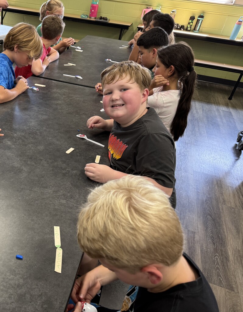 students using "trash" items to create toys