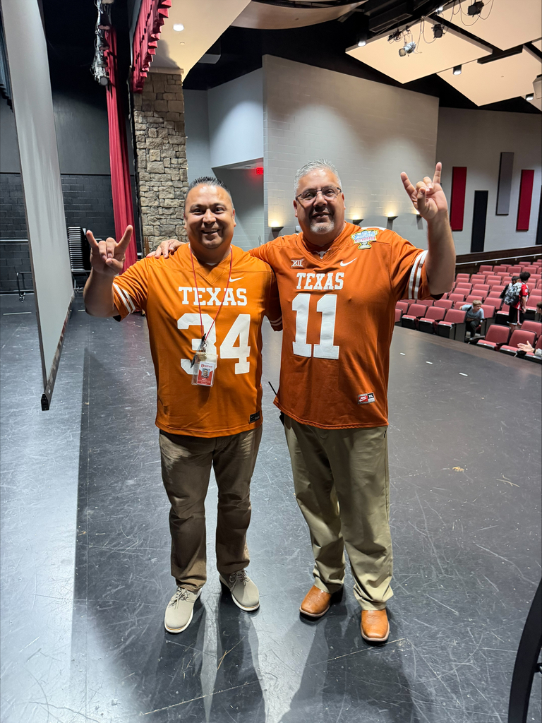 Group photo of HCMS staff members wearing Texas Longhorns apparel during Team Spirit Day. The group is gathered together to show their team pride and join in the school's celebration of football season and fall sports.