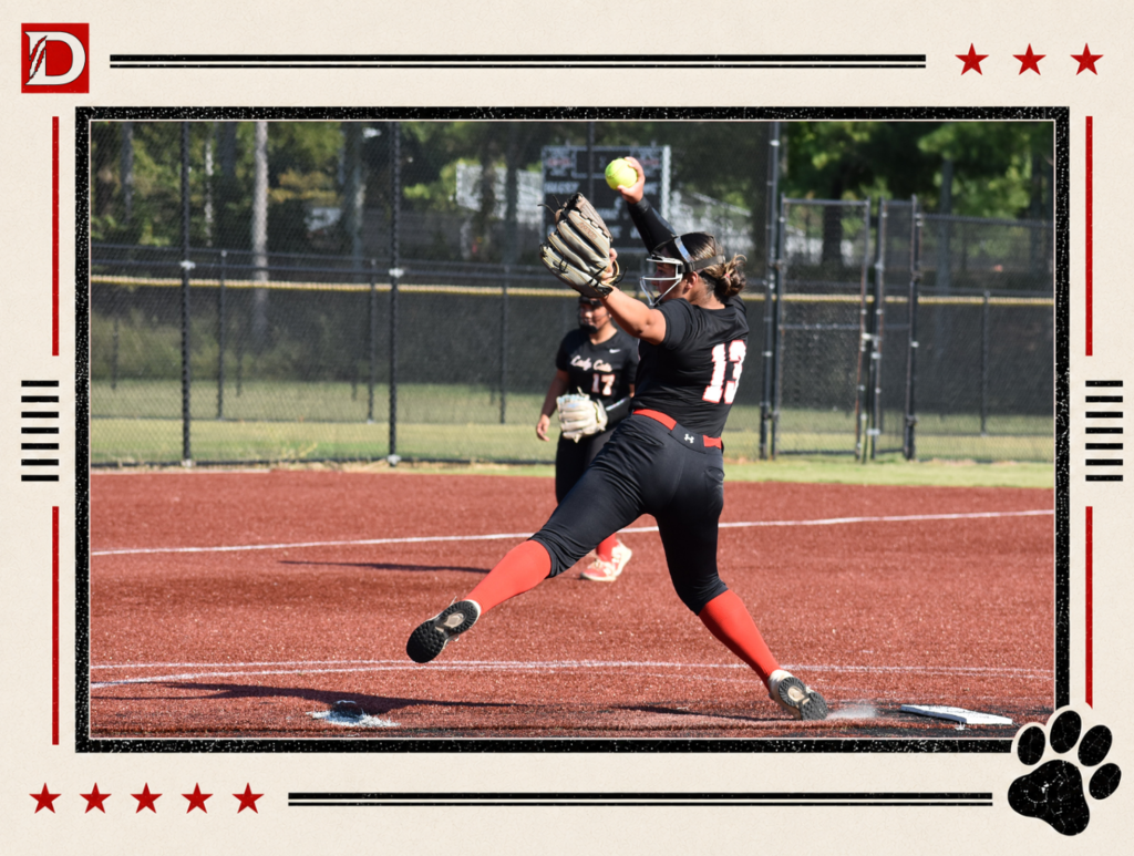 Newspaper-style Dalton Middle Athletics action photo showing a Varsity Lady Cats softball pitcher delivering a pitch. The player, wearing a black uniform with red socks, is captured mid-stride with the softball raised in her pitching hand and her glove extended forward. A teammate stands in the background. The photo is framed with red stars, black lines, the Dalton D logo, and a black paw print.