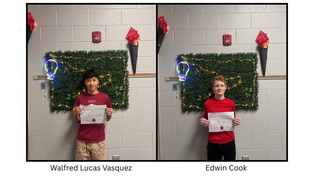 Walfred Lucas Vasquez and Edwin Cook holding a Spartan Student of the Month certificate. The student is being recognized by the 7th Grade 600 Hallway Spartans for demonstrating the character trait of courage.