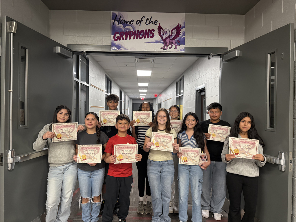 Group photo of ten students recognized as August Golden Feather recipients. Each student is holding a certificate while standing in front of a Gryphons banner. The recognition celebrates students who demonstrated courage, leadership, and positive contributions to the school community during the month of August.