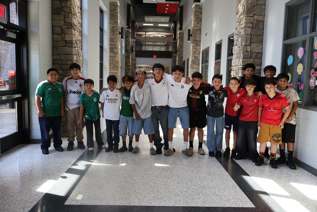 Group photo of HCMS students dressed in soccer jerseys and team apparel for Soccer Jersey Day. The event marked the beginning of the school's Hispanic Heritage Month celebration.