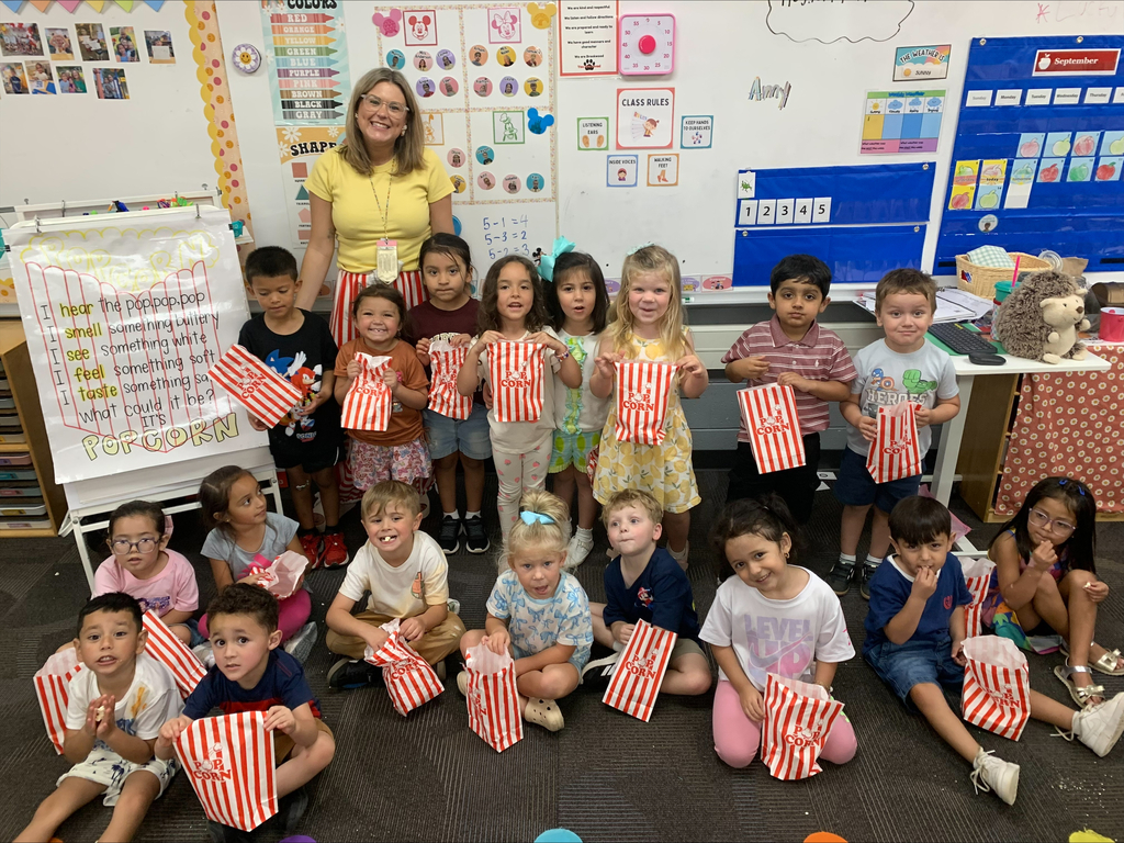 students and a teacher smiling for a picture after their lesson about popcorn and their 5 senses