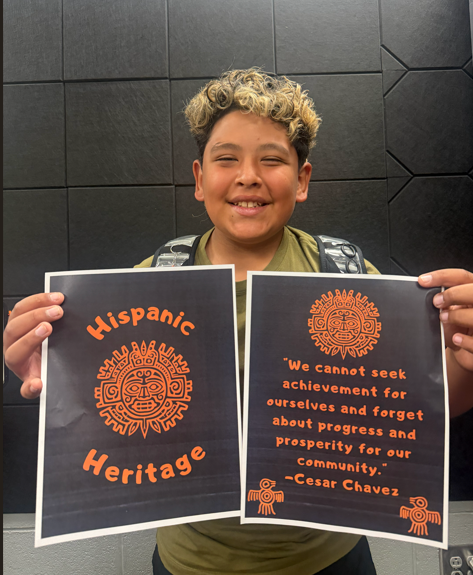 Darian holds his winning design from the HCMS Hispanic Heritage Month T-Shirt Design Contest. The design will be featured on this year's Hispanic Heritage Month shirt.