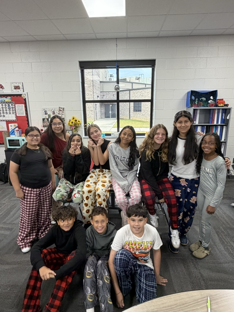 Large group of students and wearing pajamas for HCMS Pajama Day. The group is participating in Homecoming Spirit Week and posing together to celebrate school spirit and the start of the week's activities.