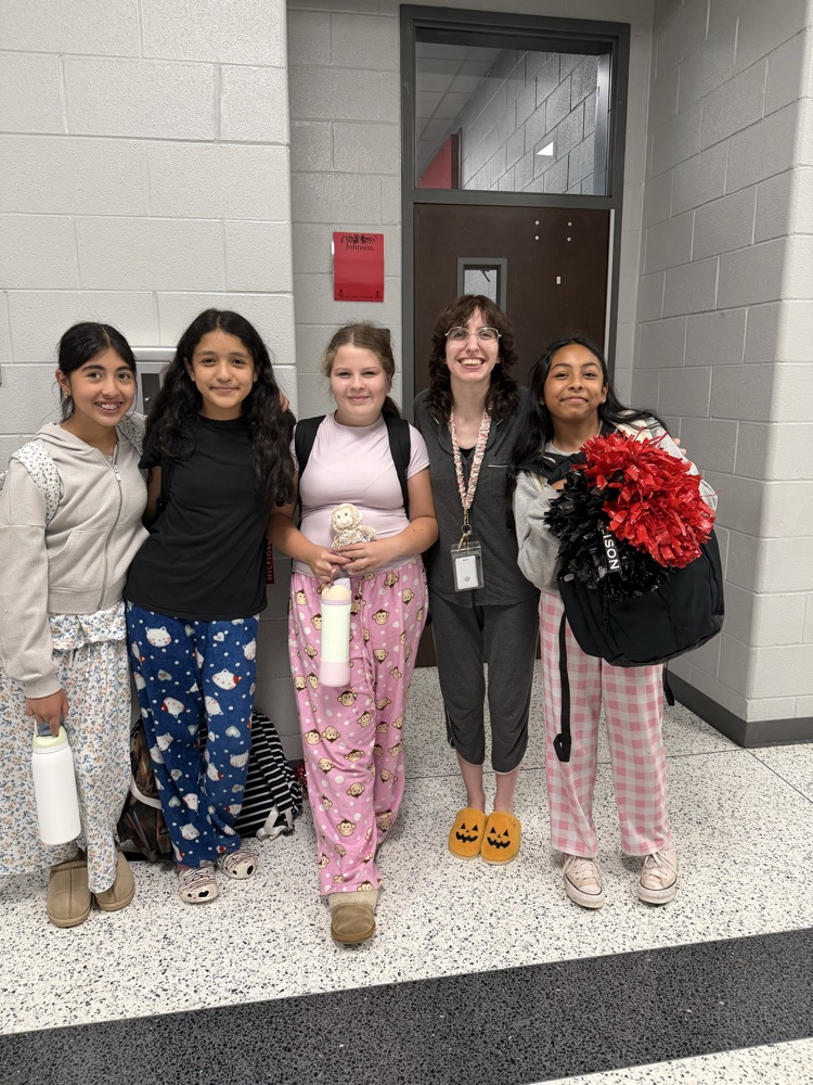 Large group of students and/or staff wearing pajamas for HCMS Pajama Day. The group is participating in Homecoming Spirit Week and posing together to celebrate school spirit and the start of the week's activities.