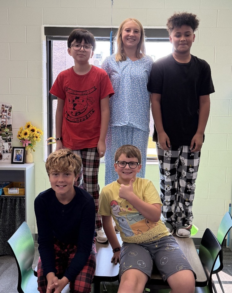 Large group of students and/or staff wearing pajamas for HCMS Pajama Day. The group is participating in Homecoming Spirit Week and posing together to celebrate school spirit and the start of the week's activities.