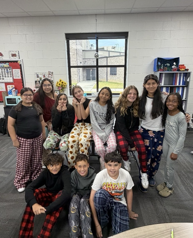 Large group of students and/or staff wearing pajamas for HCMS Pajama Day. The group is participating in Homecoming Spirit Week and posing together to celebrate school spirit and the start of the week's activities.