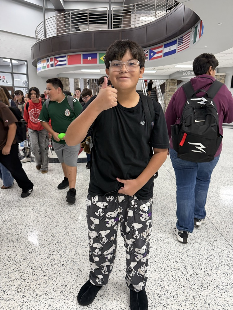Student participating in HCMS Homecoming Spirit Week by wearing pajamas for Pajama Day. The student is posing for a photo to celebrate the first dress-up day of Spirit Week.
