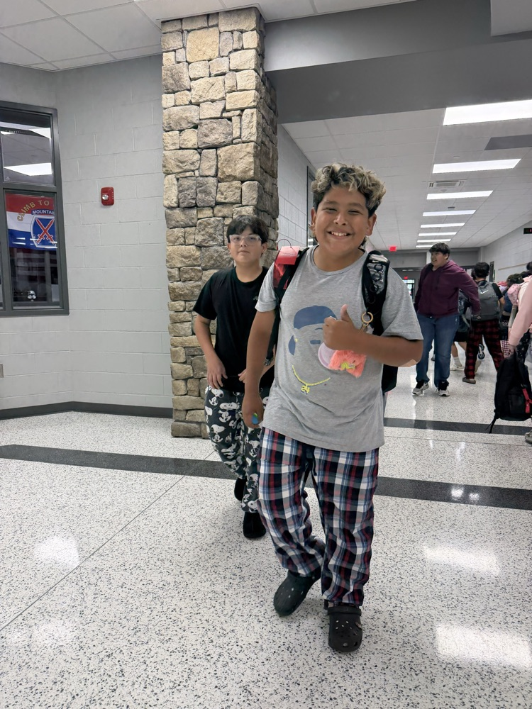 Student participating in HCMS Homecoming Spirit Week by wearing pajamas for Pajama Day. The student is posing for a photo to celebrate the first dress-up day of Spirit Week.