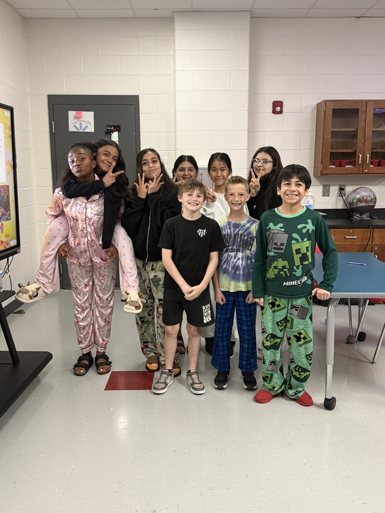 Large group of students and/or staff wearing pajamas for HCMS Pajama Day. The group is participating in Homecoming Spirit Week and posing together to celebrate school spirit and the start of the week's activities.