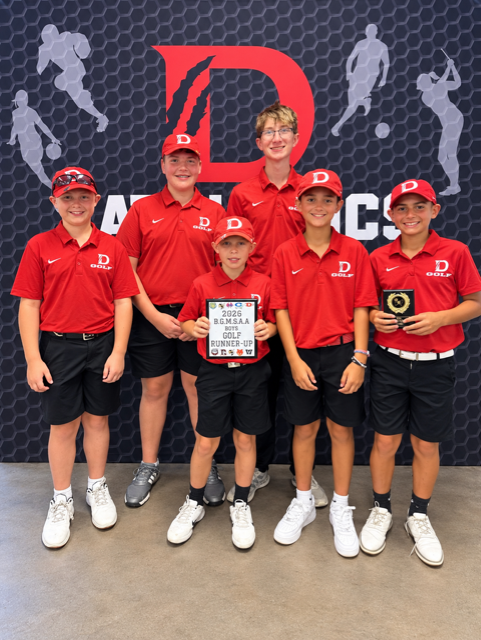 Members of the golf team holding their award plaques.