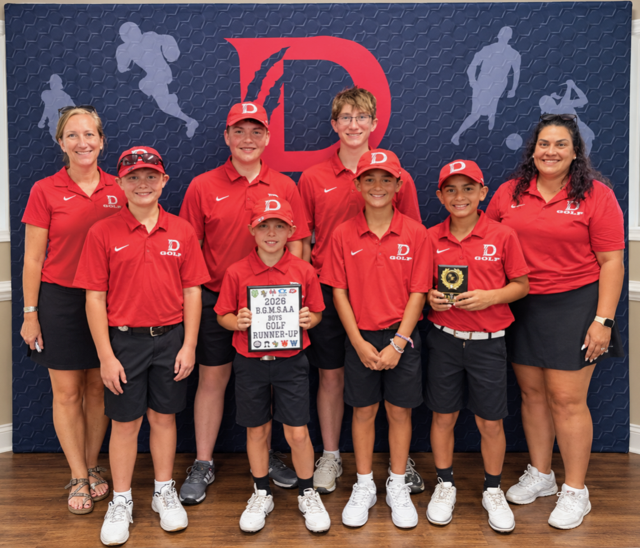 Members of the boys golf team and their coaches holding award plaques.