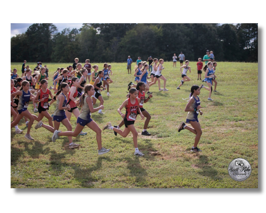 Girls cross country runners racing.