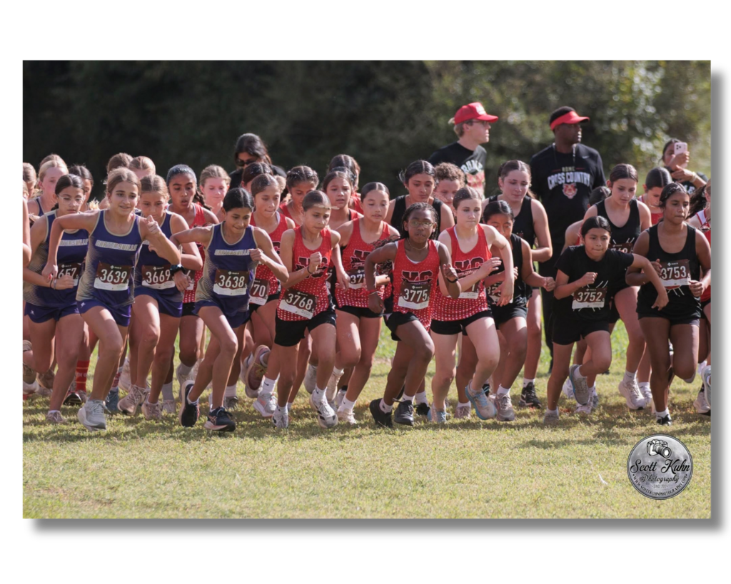 Girls cross country runners begin their race.