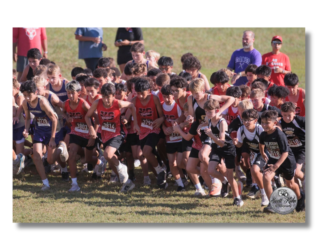 Boys cross country runners begin their race.